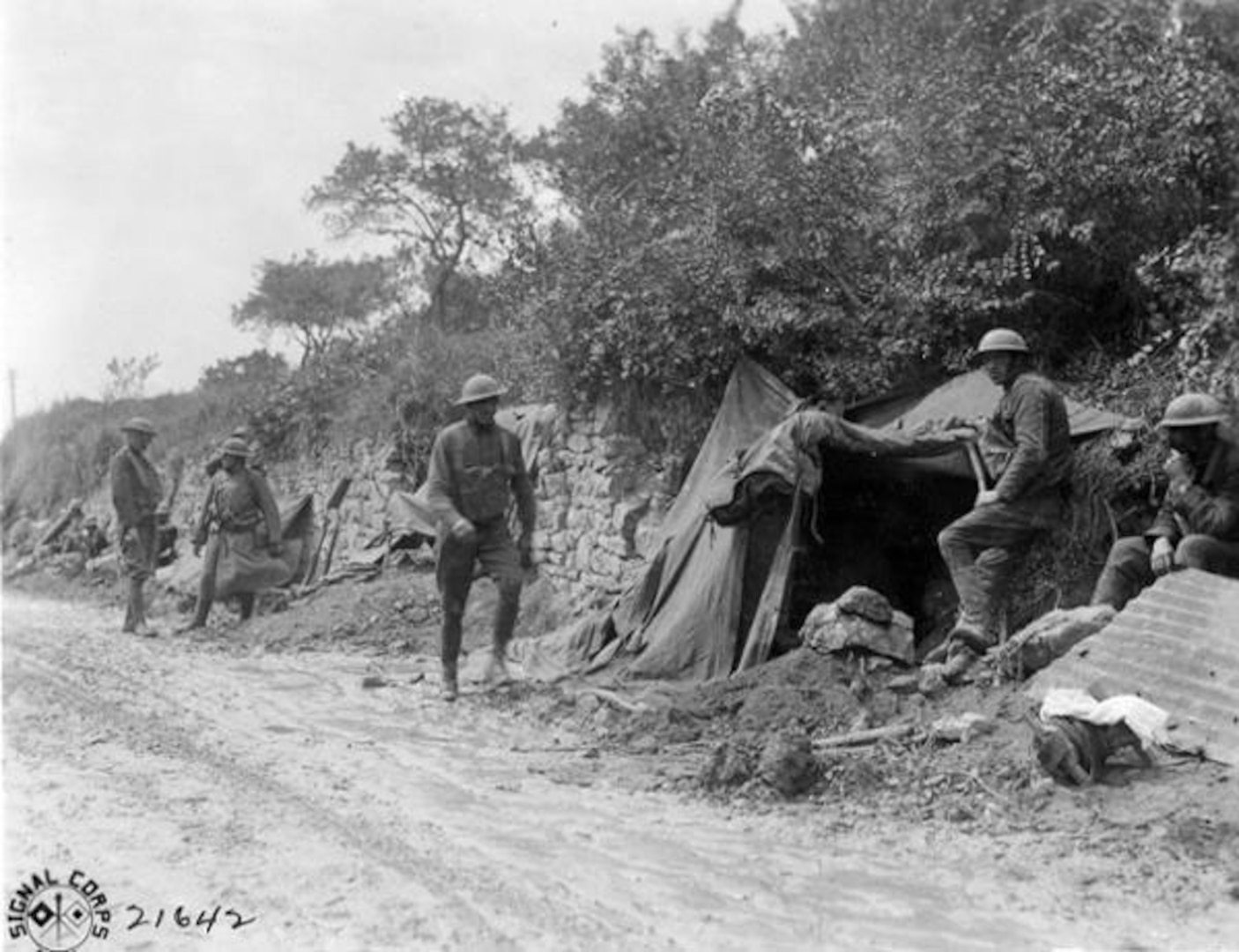 Soldiers of the 107th  Infantry Regiment of the 27th Division waiting to head for the front lines and replace British troops near St. Gillis, France, on Aug. 12, 1918, in this U.S. Army Signal Corps photo. The Americans replaced season British troops and prepared to attack in the days prior to Aug. 30, 1918.