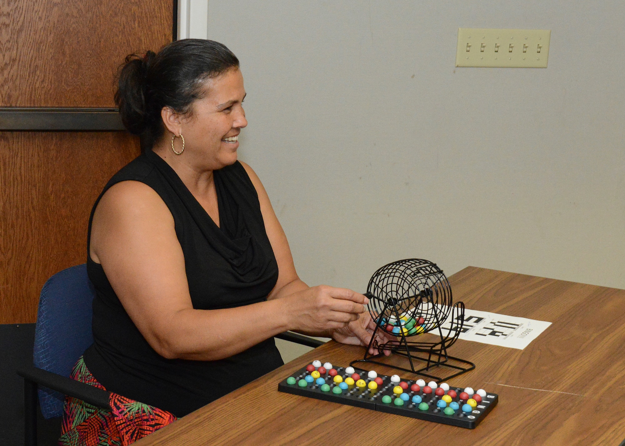 Bonnie McGee, Air Force Test Center Judge Advocate Office, spins the Bingo wheel to reveal the next Bingo ball number during Edwards AFB’s Women’s Equality Day Social held Aug. 24 at the Airman and Family Readiness Center. (U.S. Air Force photo by Kenji Thuloweit)