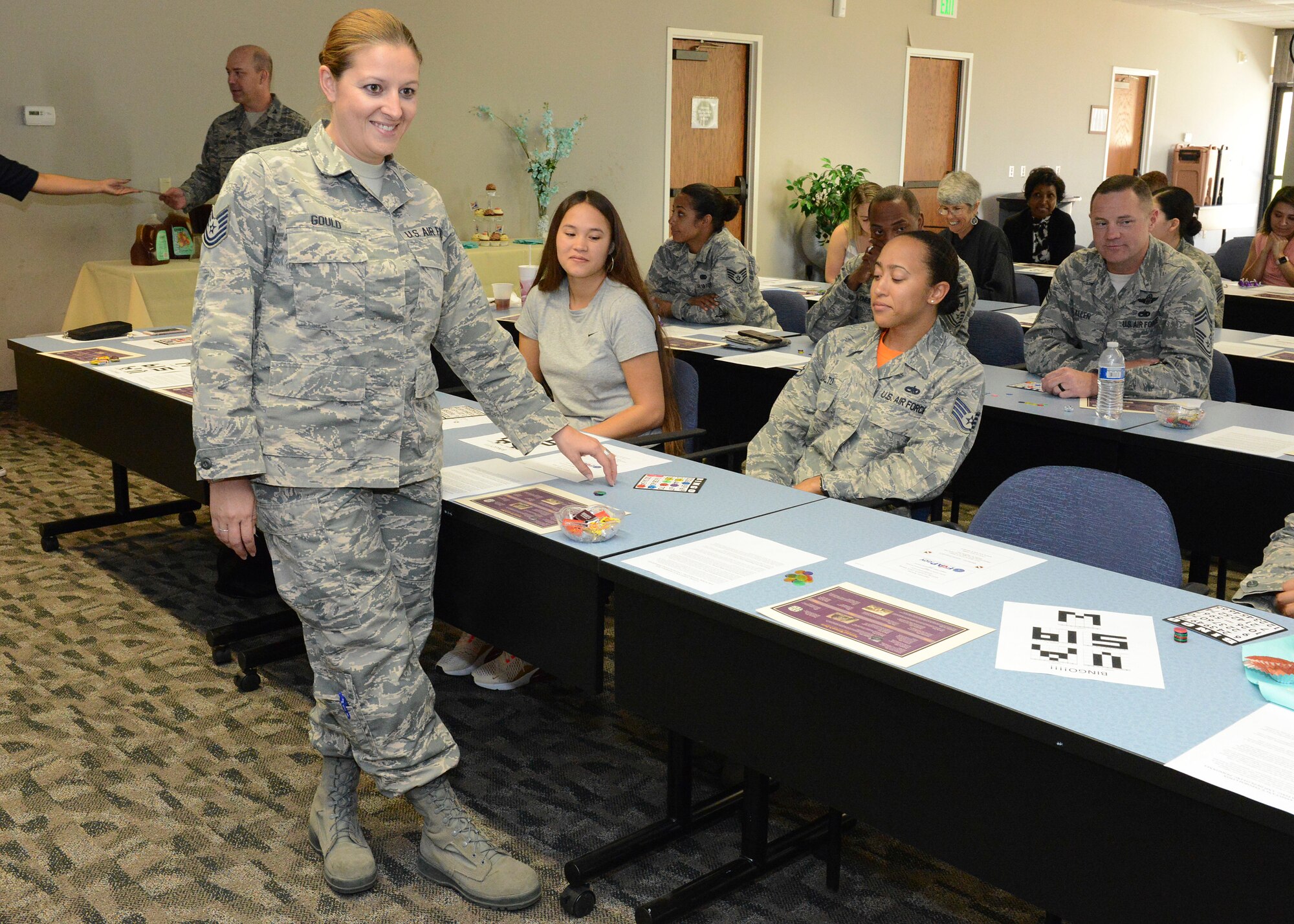 Tech. Sgt. Elizabeth Gould, 412th Logistics Readiness Squadron (left), verifies Staff Sgt. Ciarra Malto’s Bingo win during Edwards AFB’s Women’s Equality Day Social held Aug. 24 at the Airman and Family Readiness Center. Gould helped organize this year’s observance. (U.S. Air Force photo by Kenji Thuloweit)