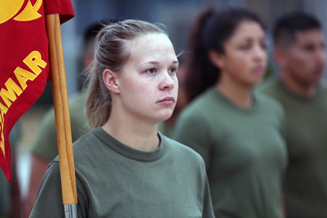 Sgt. Ashton Reynolds, an administrative clerk for Headquarters and Headquarters Squadron, holds the H&HS guideon before a squadron run on the flightline of Marine Corps Air Station Miramar, Calif., Aug. 21. Lt. Col. Michael A. Spears, commanding officer of H&HS, led his Marines during a final squadron run before changing command with Lt. Col. Alan J. Clarke, future commanding officer of H&HS. (U.S. Marine Corps photo by Cpl. Jake M.T. McClung)