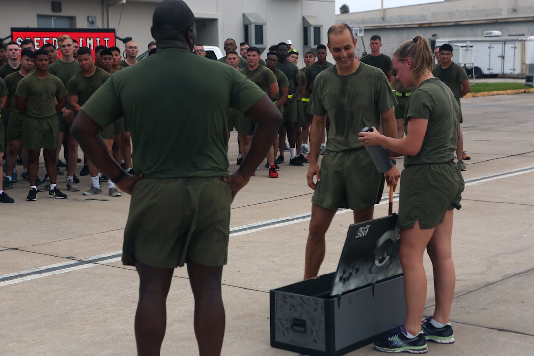 Sgt. Ashton Reynolds, an administrative clerk for Headquarters and Headquarters Squadron, presents Lt. Col. Michael A. Spears, commanding officer of H&HS, with a footlocker on behalf of H&HS Marines following a squadron run at Marine Corps Air Station Miramar, Calif., Aug. 21. Spears led his Marines during a final squadron run before changing command with Lt. Col. Alan J. Clarke, future commanding officer of HHS. (U.S. Marine Corps photo by Cpl. Jake M.T. McClung)