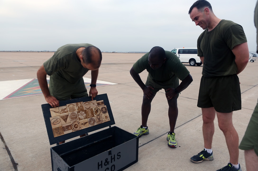 Lt. Col. Michael A. Spears, commanding officer of Headquarters and Headquarters Squadron, left, views the footlocker, Marines with H&HS gave him following a squadron run at Marine Corps Air Station Miramar, Calif., Aug. 21. Spears led his Marines during a final squadron run before changing command with Lt. Col. Alan J. Clarke, future commanding officer of H&HS. (U.S. Marine Corps photo by Cpl. Jake M.T. McClung)