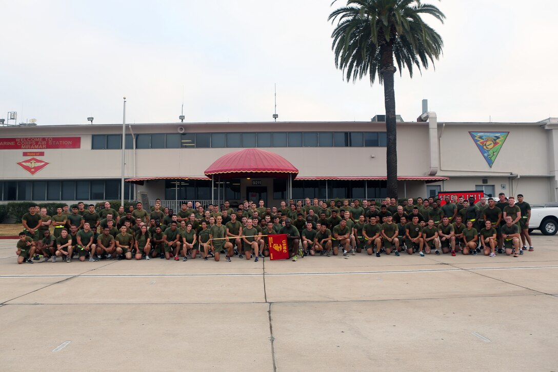 Marines with Headquarters and Headquarters Squadron pose for a group photo after completing a squadron run at Marine Corps Air Station Miramar, Calif., Aug. 21. Lt. Col. Michael A. Spears led his Marines during a final squadron run before changing command with Lt. Col. Alan J. Clarke, future commanding officer of H&HS. (U.S. Marine Corps photo by Cpl. Jake M.T. McClung)
