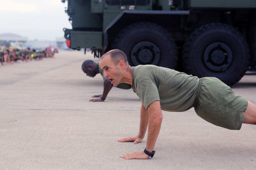 Lt. Col. Michael A. Spears, commanding officer of Headquarters and Headquarters Squadron, calls repetition for pushups after a run with his squadron at Marine Corps Air Station Miramar, Calif., Aug. 21. Spears led his Marines during a final squadron run before changing command with Lt. Col. Alan J. Clarke, future commanding officer of H&HS. (U.S. Marine Corps photo by Sgt. Daniel Auvert)