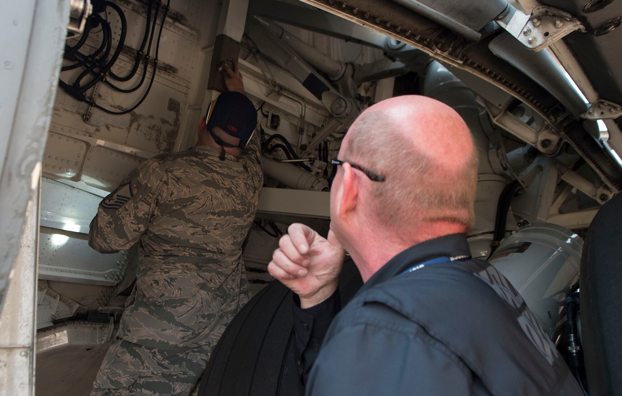 U.S. Air Force Master Sgt. Matthew Dowton, an Air Force corrosion manager assigned to Air Force Corrosion Protection Office, and Daniel Mars, a research corrosion analyst assigned to AFCPO, examine the exterior of a C-17 Globemaster III for corrosion August 22, 2018, Altus Air Force Base, Oklahoma. AFCPO dispatches teams to Air Force bases in order to examine aircraft for corrosion.