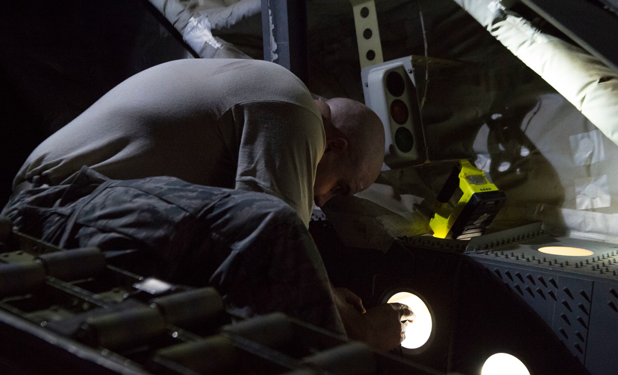 U.S. Air Force Master Sgt. Matthew Dowton, an Air Force corrosion manager assigned to Air Force Corrosion Protection Office, looks for corrosion and standing water in the back of a C-17 Globemaster III August 22, 2018, Altus Air Force Base, Oklahoma. AFCPO dispatches teams to Air Force bases in order to examine aircraft for corrosion.