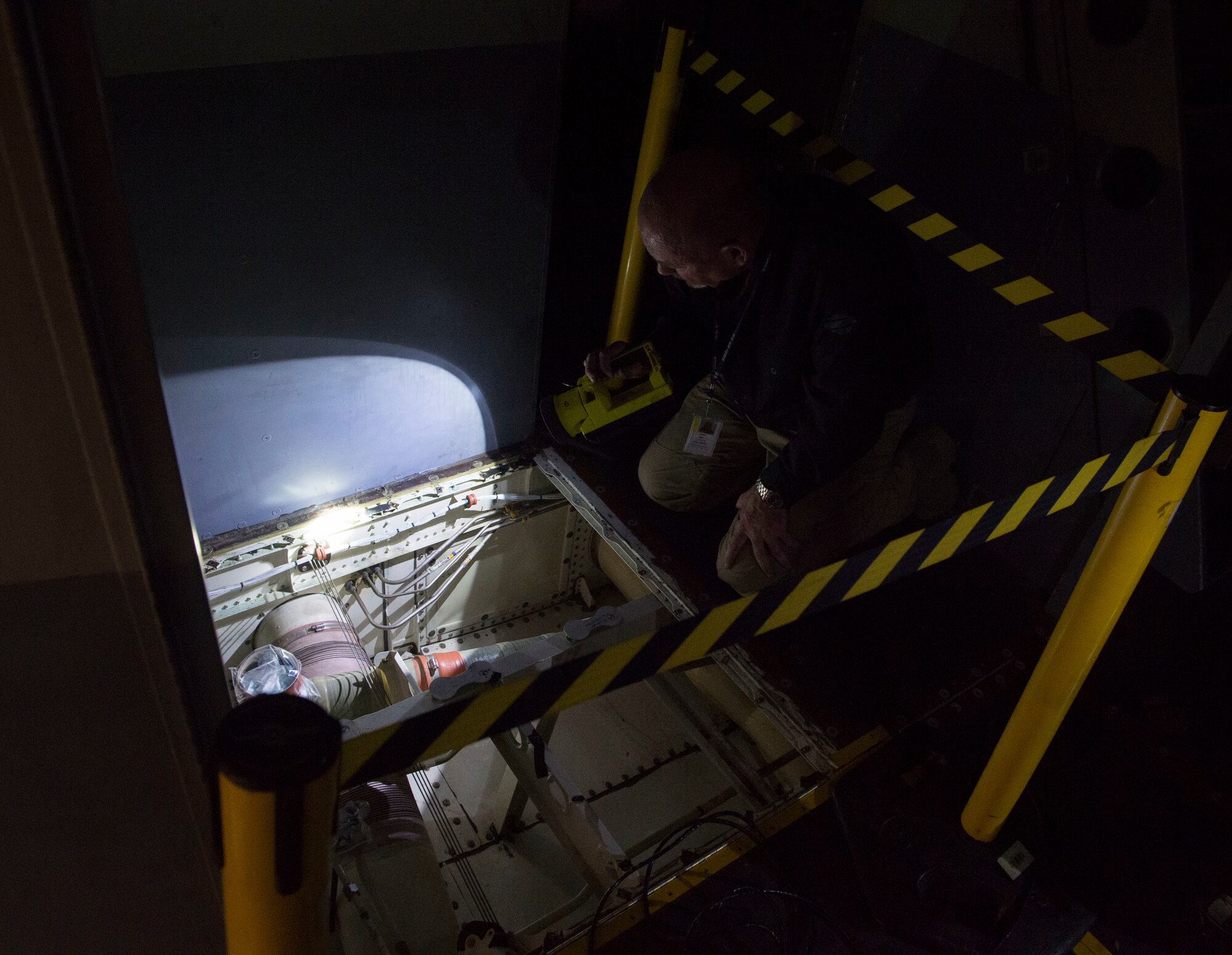 Daniel Mars, a research corrosion analyst assigned to Air Force Corrosion Protection Office, searches the lavatory area of a C-17 Globemaster III for chemical residue and damage August 22, 2018, Altus Air Force Base, Oklahoma. AFCPO dispatches teams to Air Force bases in order to examine aircraft for corrosion.