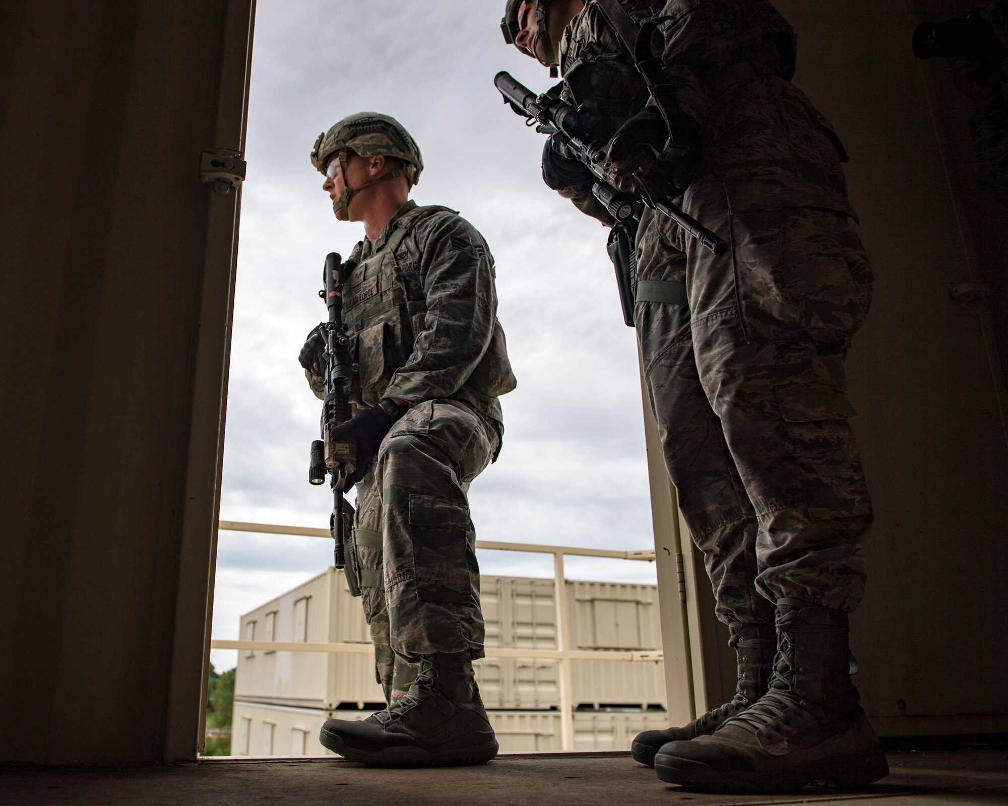 U.S. Air Force Senior Airman Aaron Lee, 9th Security Forces Squadron patrolman, and Airman 1st Class Jacob D’Agostino, 633rd Security Forces Squadron response force leader, clear a building during Air Combat Command’s Defender Challenge team selection at Joint Base Langley-Eustis, Virginia, August 20, 2018.