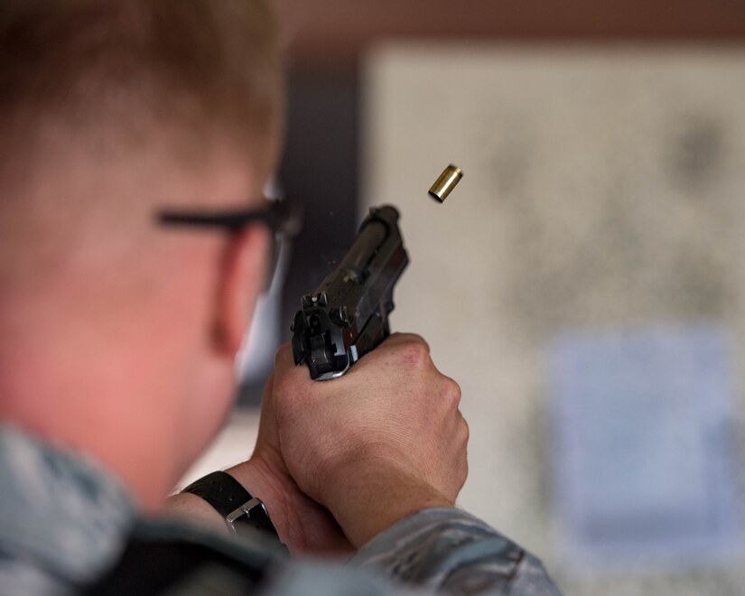 U.S. Air Force Senior Airman Aaron Lee, 9th Security Forces Squadron patrolman, fires an M9 pistol during Air Combat Command’s Defender Challenge team selection at Joint Base Langley-Eustis, Virginia, August 20, 2018.