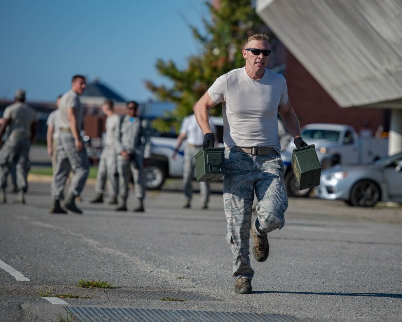 U.S. Air Force Staff Sgt. Aaron Vanley, 633rd Security Forces Squadron base defense operations center controller, carries ammunition cans during Air Combat Command’s Defender Challenge team selection at Joint Base Langley-Eustis, Virginia, August 24, 2018.