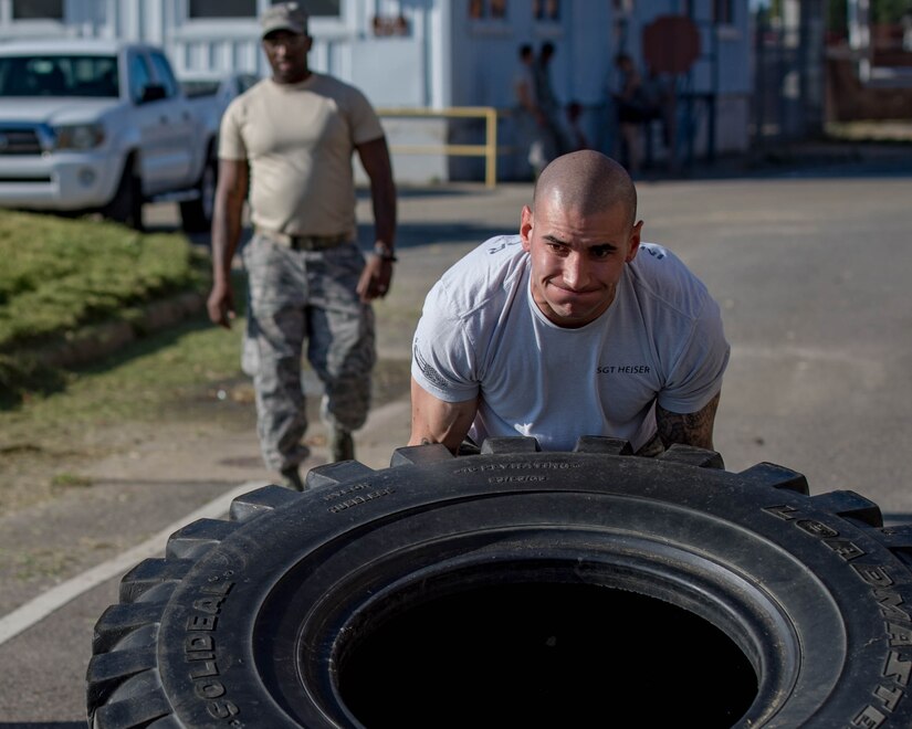U.S. Air Force Tech. Sgt. Matthew Heiser, 49th Security Forces Squadron flight chief, performs tire flips during Air Combat Command’s Defender Challenge team selection at Joint Base Langley-Eustis, Virginia, August 24, 2018.
