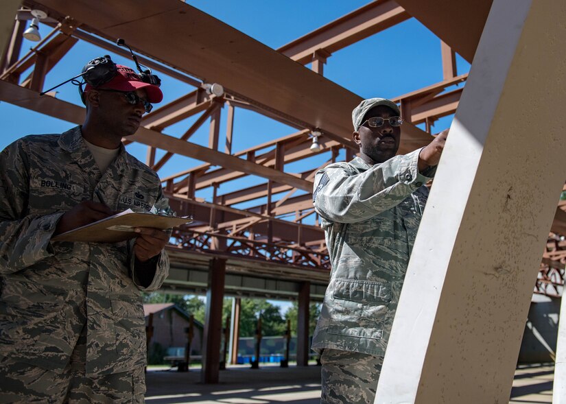 U.S. Air Force Tech. Sgt. Ajamu Bolling, 633rd security Forces Squadron combat arms training and maintenance instructor, and Tech. Sgt. Alexis Rice, Air Combat Command, Directorate of Logistics Engineering and Force Protection NCO in charge of mission assurance, assess the targets targets during Air Combat Command’s Defender Challenge team selection at Joint Base Langley-Eustis, Virginia, August 24, 2018.