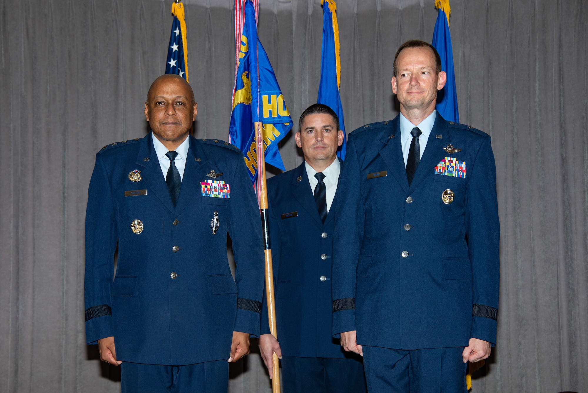 Maxwell AFB, Ala. - Lieutenant General Anthony Cotton, commander and president of Air University (left), presents the Jeanne M. Holm Center for Officer Accessions and Citizen Development guidon to Brigadier General Christopher J. Niemi during a change of command ceremony, August 23, 2018. Holm Center oversees Air Force Junior ROTC, a citizen development program with more than 143,000 cadets in 890 high schools worldwide as well as 16,700 Air Force ROTC cadets at 1,250 colleges and universities nationwide and 3,300 cadets annually in Air Force Officer Training School at Maxwell AFB.(US Air Force photo by Melanie Rodgers Cox)