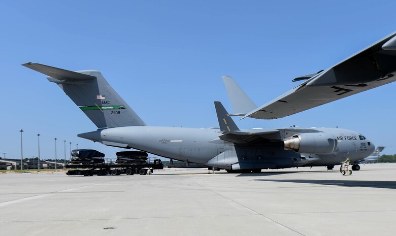 U.S. Army Soldiers load equipment into a C-17 Globemaster III from McChord Field, Wash., during Exercise Predictable Iron at Pope Field, N.C., Aug. 23, 2018. Airmen from the 62nd Airlift Wing participated in the joint exercise with the 82nd Airborne Division. (U.S. Air Force photo by Senior Airman Tryphena Mayhugh)