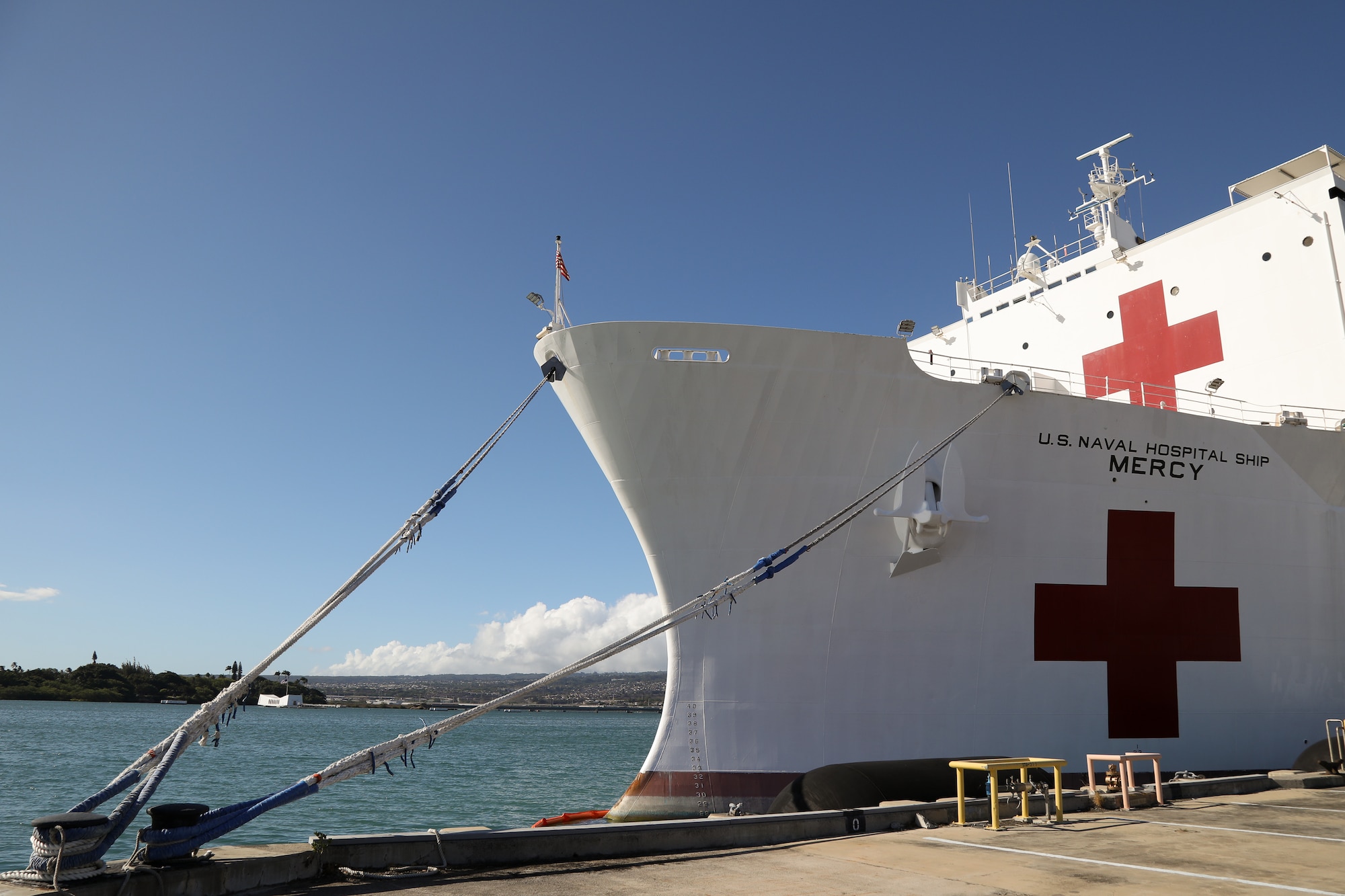 The USNS Mercy, docked alongside the USS Arizona Memorial July 9, 2018, on Joint Base Pearl Harbor – Hickam is a hospital ship that provides various medical services in the event of crisis. Of interest to members of the 446th Aeromedical Squadron are not only capabilities but how patient movement is accomplished. (U.S. Air Force photo by David L. Yost)