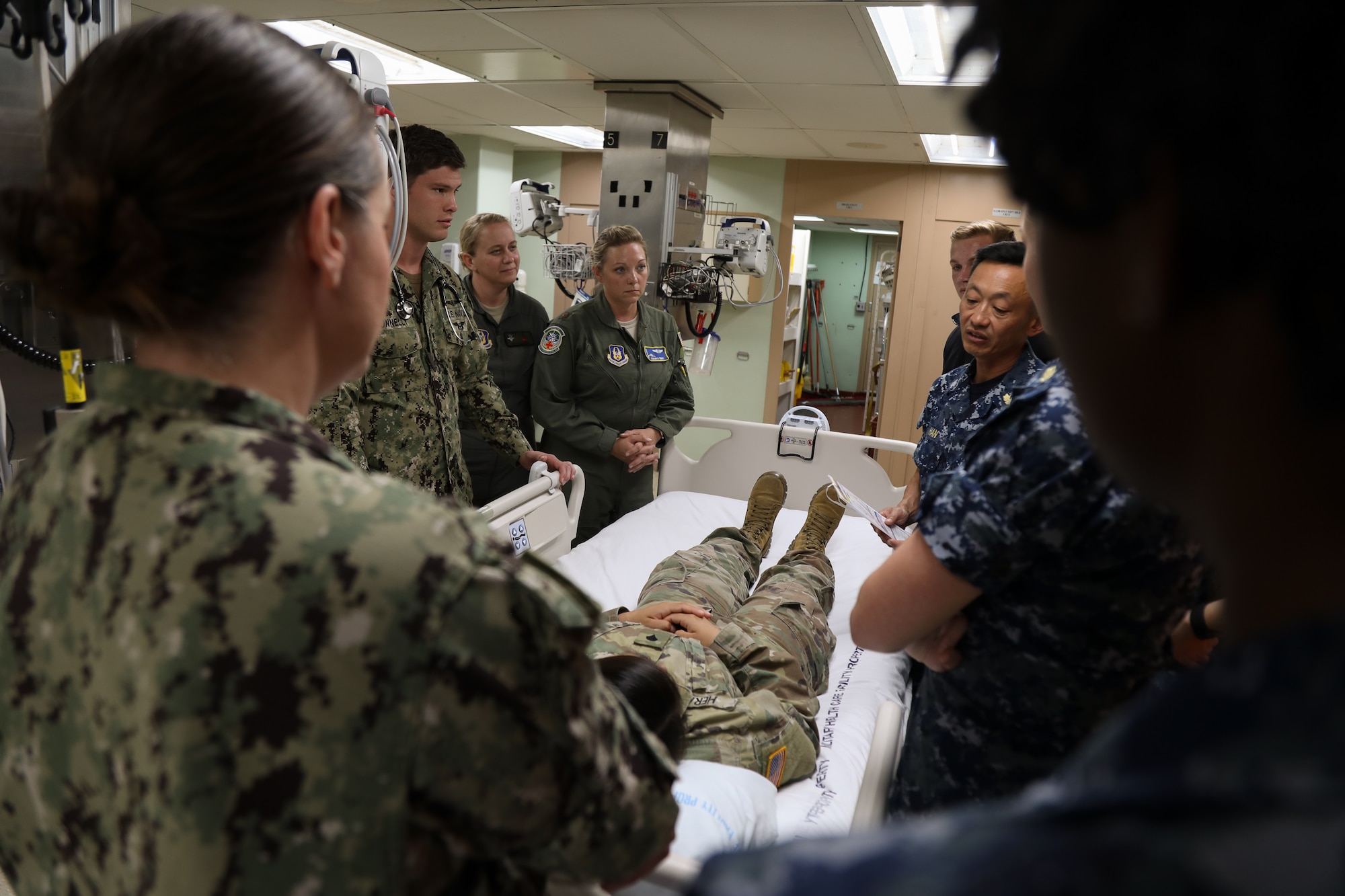 Maj. Claudia Perry, a flight nurse with the 446th Aeromedical Squadron, listens to a patient evaluation aboard the hospital ship USNS Mercy July 9, 2018, on Joint Base Pearl Harbor – Hickam. Live mock causality patients from Joint Base Lewis – McChord were transported to the ship by a C-17 Globemaster III. (U.S. Air Force photo by David L. Yost)