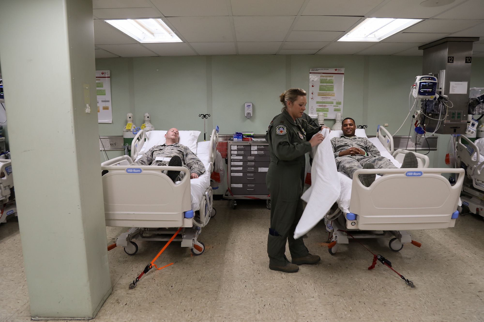 Maj. Claudia Perry, a flight nurse with the 446th Aeromedical Squadron, checks on patients participating in a combined training event aboard the hospital ship USNS Mercy July 9, 2018, on Joint Base Pearl Harbor – Hickam. Members of the 446th AES were able to tour the ship along with training participants. (U.S. Air Force photo by David L. Yost)