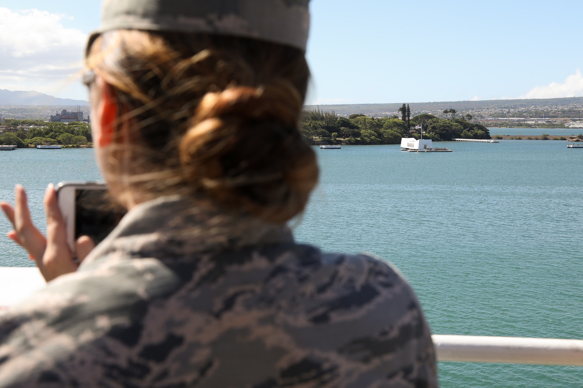 Airman 1st Class Kelsey Hanley assigned to the 62nd Medical Squadron, Joint Base Lewis – McChord, takes a photo of the USS Arizona Memorial from the top of the USNS Mercy July 9, 2018, on Joint Base Pearl Harbor – Hickam. Training participants were given a tour along with a briefing of capabilities of the USNS Mercy. (U.S. Air Force photo by David L. Yost)