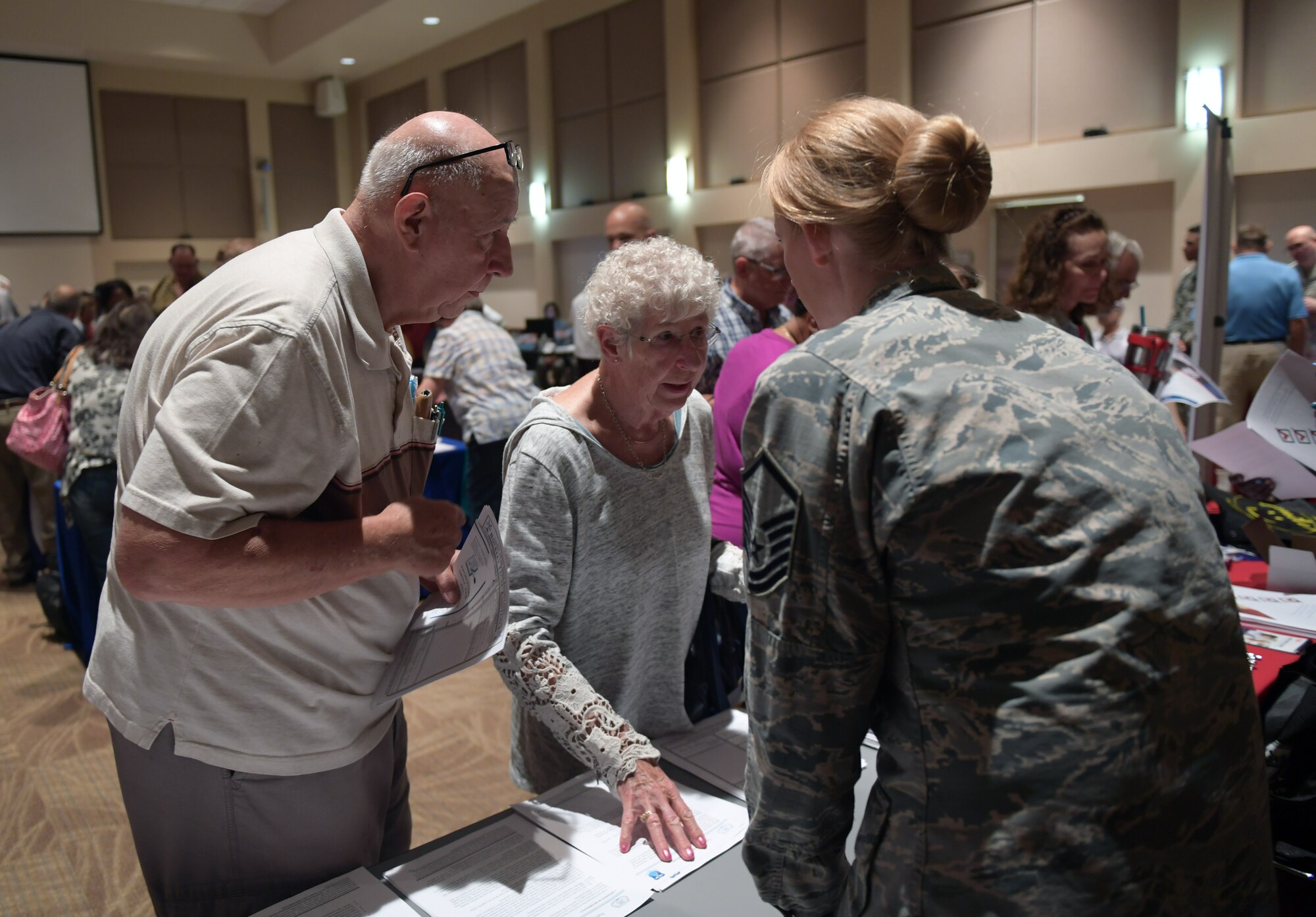 Master Sgt. Leah Calahan, far right, 460th Space Wing law office superintendent, speaks to attendees about legal services available to retirees during the Retiree Appreciation Day event at Buckley Air Force Base, Colorado, Aug. 25, 2018.