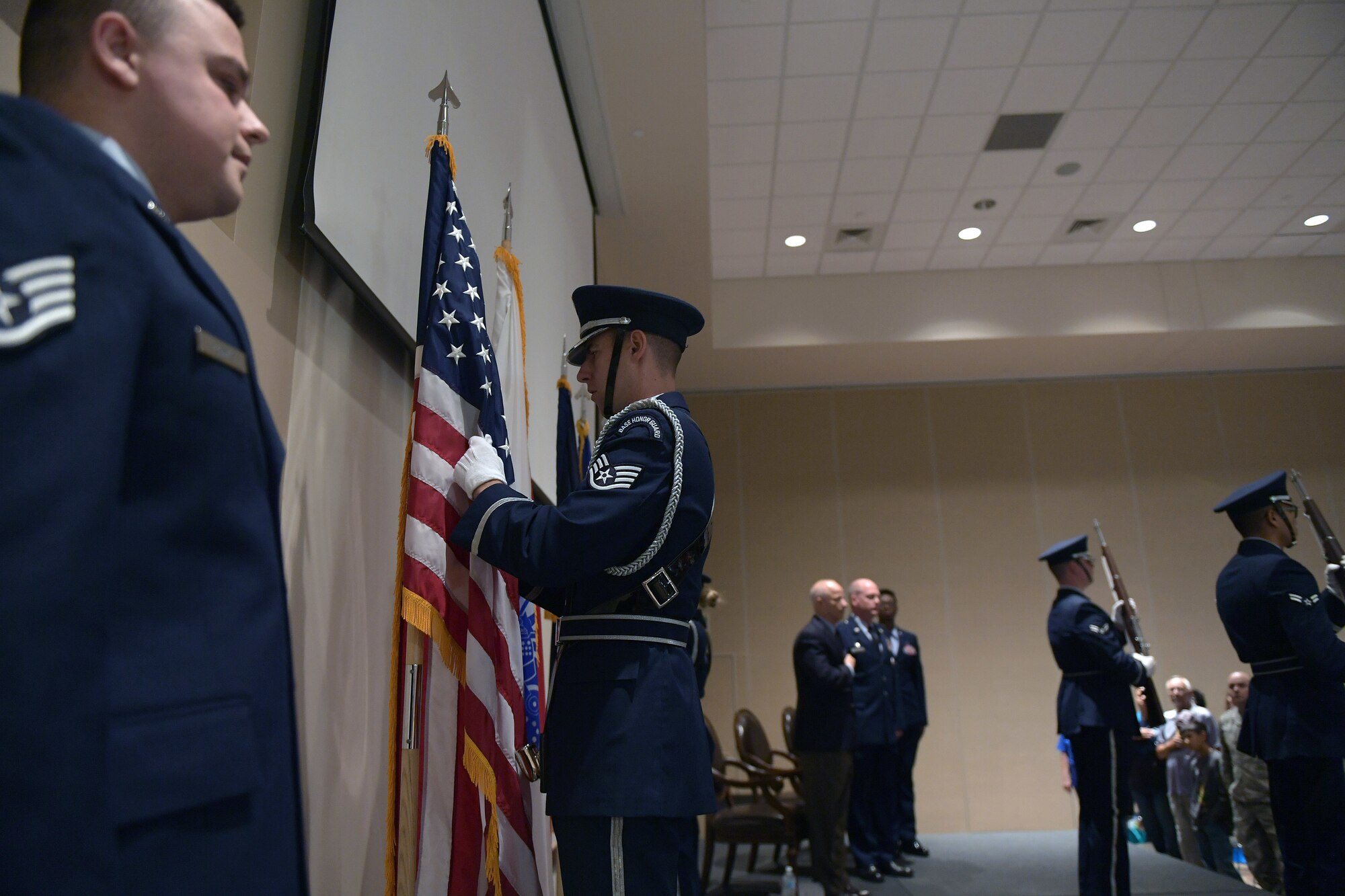 Ceremonial guardsmen with the Mile High Honor Guard perform a colors detail prior to the start of the Retiree Appreciation Day event at Buckley Air Force Base, Colorado, Aug. 25, 2018.
