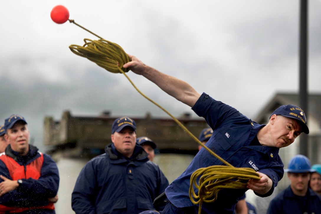 A Coast Guardsman tosses a heaving line during competition.