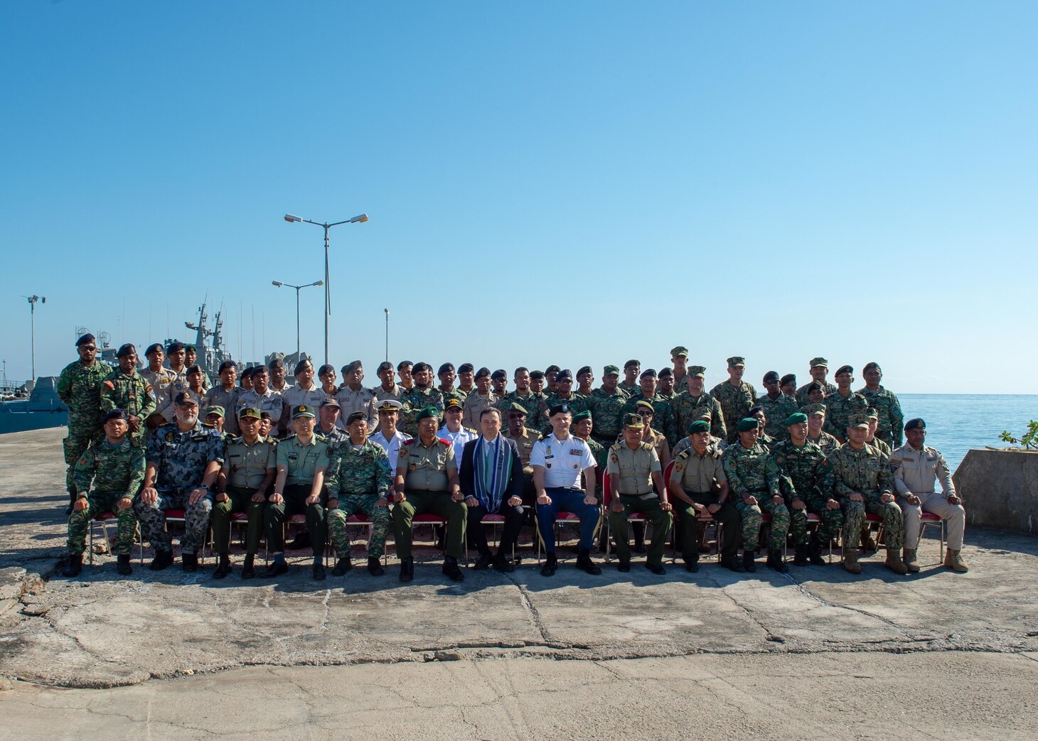 Sailors assigned to Coastal Riverine Group (CRG) 1 Det. Guam and members of the Timor-Leste Defense Force and the National Police of Timor-Leste pose for a photo during the opening ceremony for CARAT Timor-Leste 2018 at Hera Naval Base, Aug. 27, 2018. CRG 1 Det. Guam is assigned to Commander, Task Force (CTF) 75, the primary expeditionary task force responsible for the planning and execution of coastal riverine operations, explosive ordnance disposal, diving engineering and construction, and underwater construction in the U.S. 7th fleet area of operations. CARAT Timor-Leste 2018 is designed to address shared maritime security concerns, build relationships and enhance interoperability among participating forces.