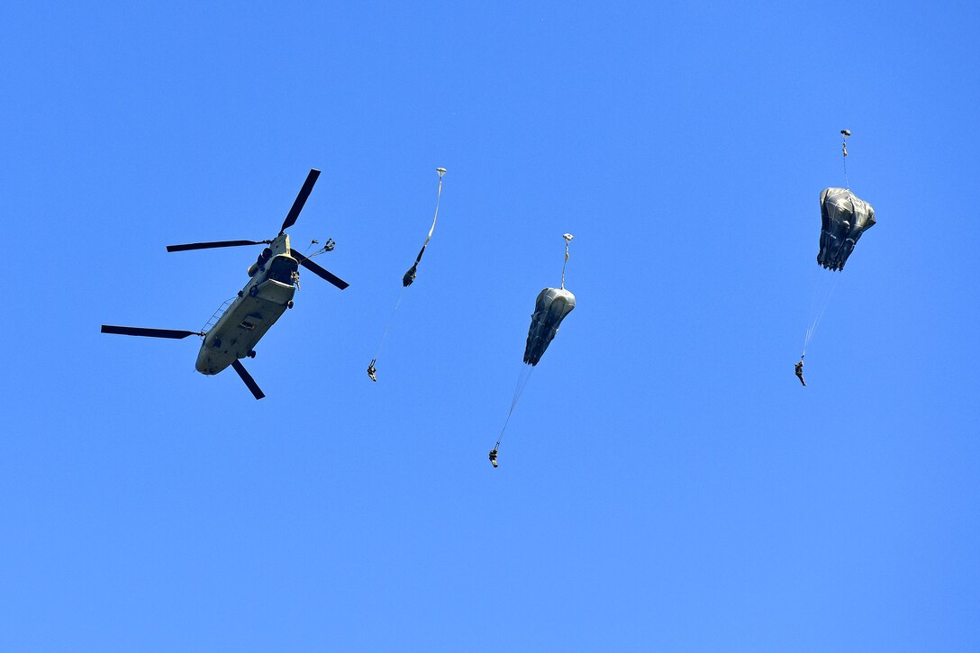U.S. paratroopers exit a CH-47 Chinook helicopter conducting airborne operation.