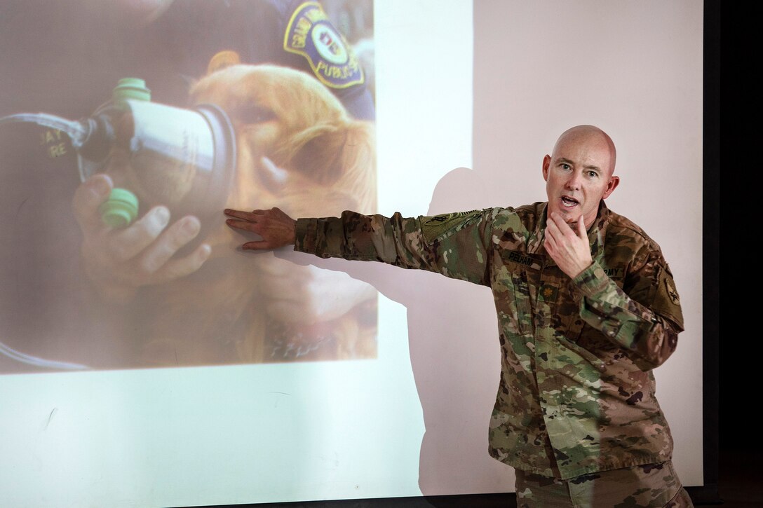 A soldier teaches canine tactical combat casualty care to troops.