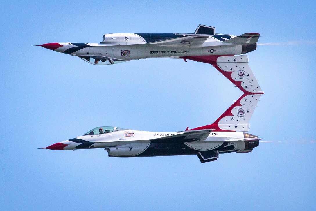 Air Force F-16 Fighting Falcon aircraft perform a calypso pass.