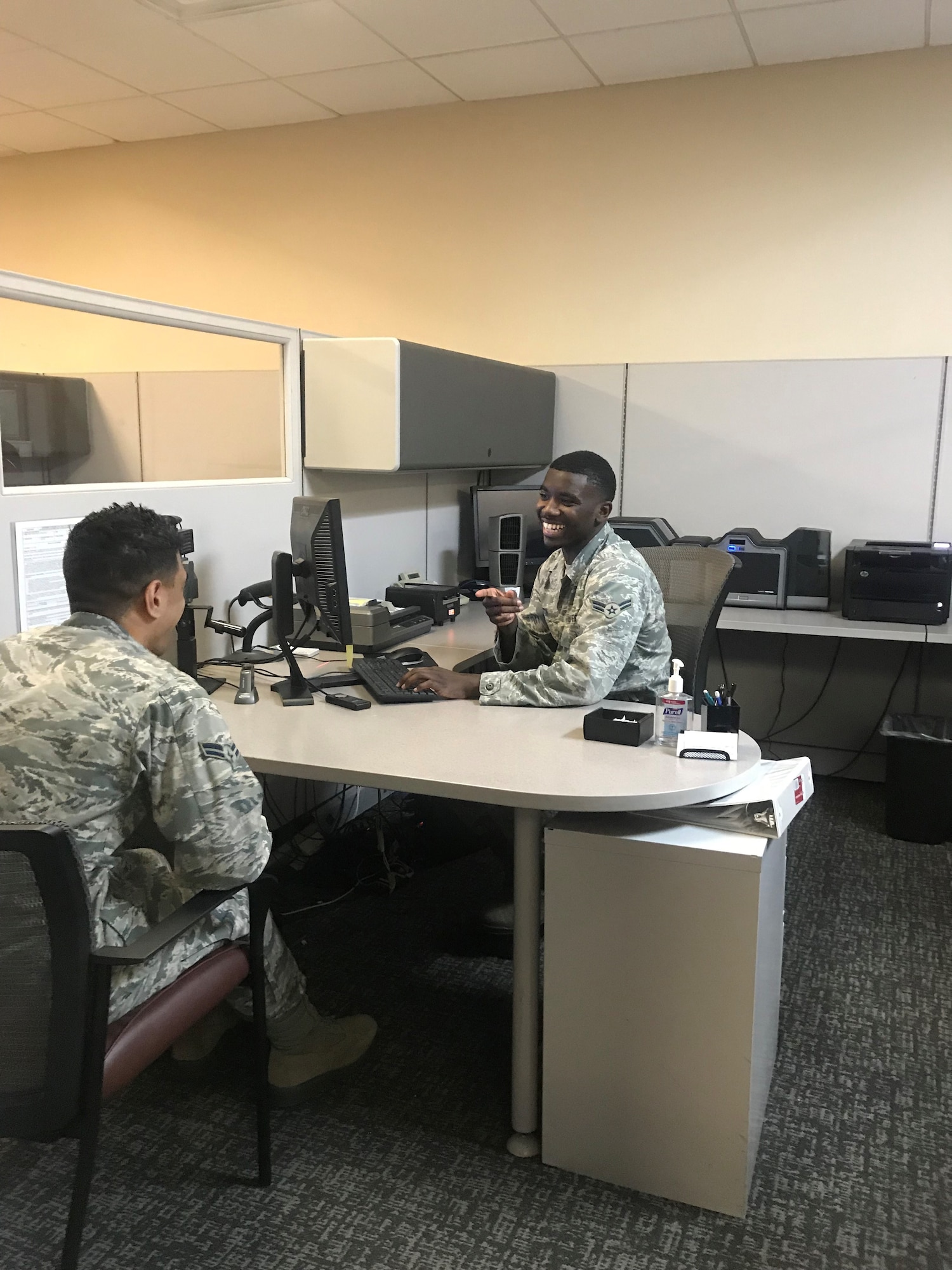 Airman First Class Melchiezedek Martin, customer support apprentice, takes a photo for a customer’s CAC at the 88th Air Base Wing Military Personnel Flight, Wright-Patterson Air Force Base, Ohio. (U.S. Air Force Photo/Elizabeth Clinch)