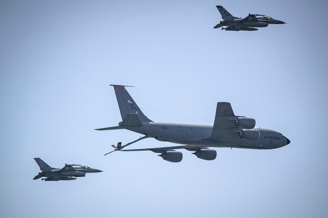 An Air Force KC-135R Stratotanker flies in formation with F-16C Fighting Falcon aircraft.