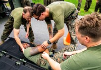 Medical personnel assigned to 3rd Medical Battalion, 3rd Marine Logistics Group, assess a simulated casualty during Navy Medicine Augmentation Program pre-deployment training at Medical Simulation Training Center South, Okinawa, Japan, Aug. 25, 2018.  Medical personnel with 3rd Med. Bn., 3rd MLG, worked with medical augments to prepare Role II medical facilities. Role II facilities provide a place for injured service members to be received while providing enhanced capabilities such as ultrasound, X-ray and surgery. (U.S. Marine Corps photo by Cpl. Joshua Pinkney)