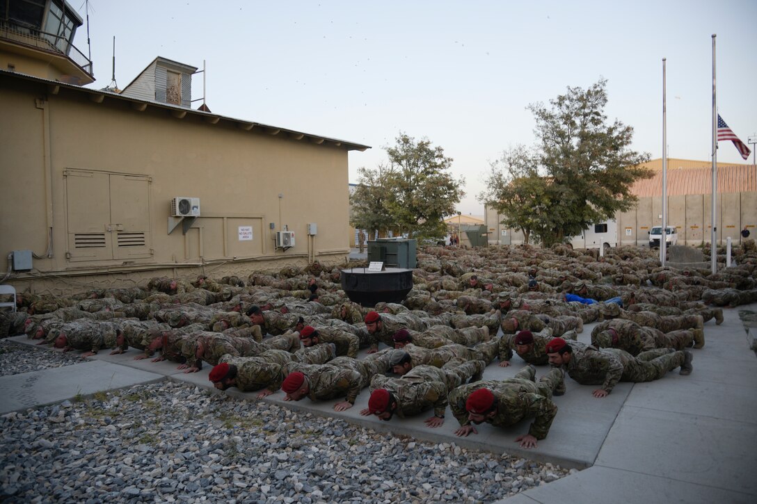 Members of the Special Operations Community and Team Bagram complete push-ups in remembrance of Medal of Honor recipient, U.S. Air Force Master Sgt. John Chapman during a ceremony on Bagram Airfield, Afghanistan, August 28, 2018. Chapman was posthumously given the Medal of Honor along with the rank of Master Sgt. for his actions during the Battle of Takur Ghar, also known as Roberts Ridge, in Afghanistan in March 2002. (U.S. Air Force photo by Staff Sgt. Kristin High)