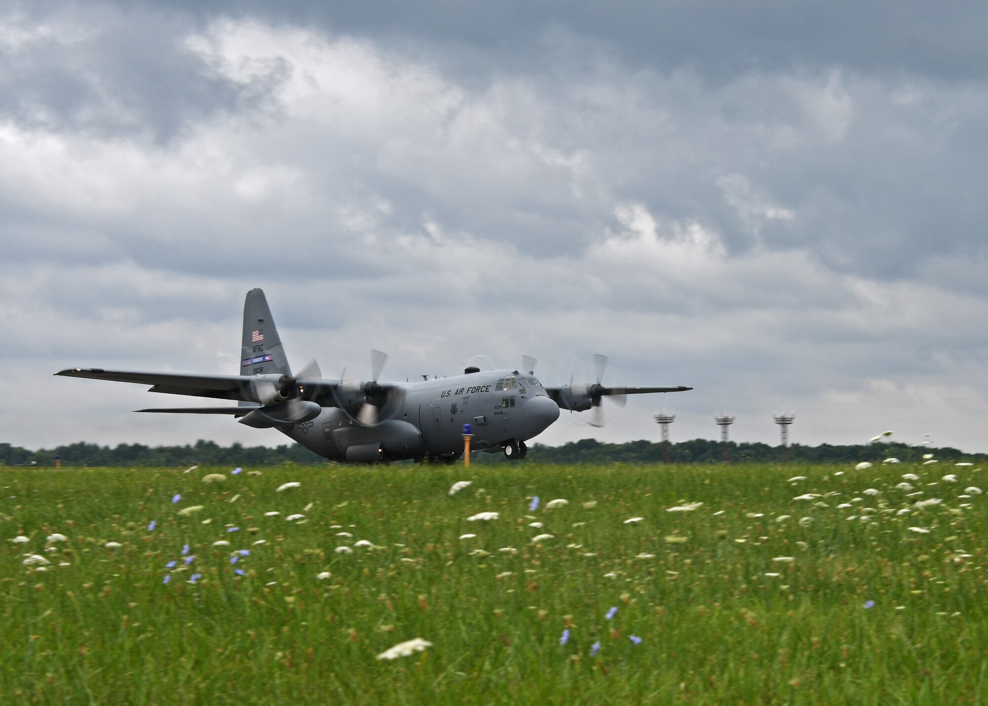 A C-130H3 Hercules aircraft from the 94th Airlift Wing performs a touch and go at Youngstown Air Reserve Station, Ohio, Aug. 8, 2018. During touch and goes, the aircraft descends to the runway, lands, and then takes back off again. This is done to help simulate tactical operations. (U.S. Air Force photo by Staff Sgt. Miles Wilson)