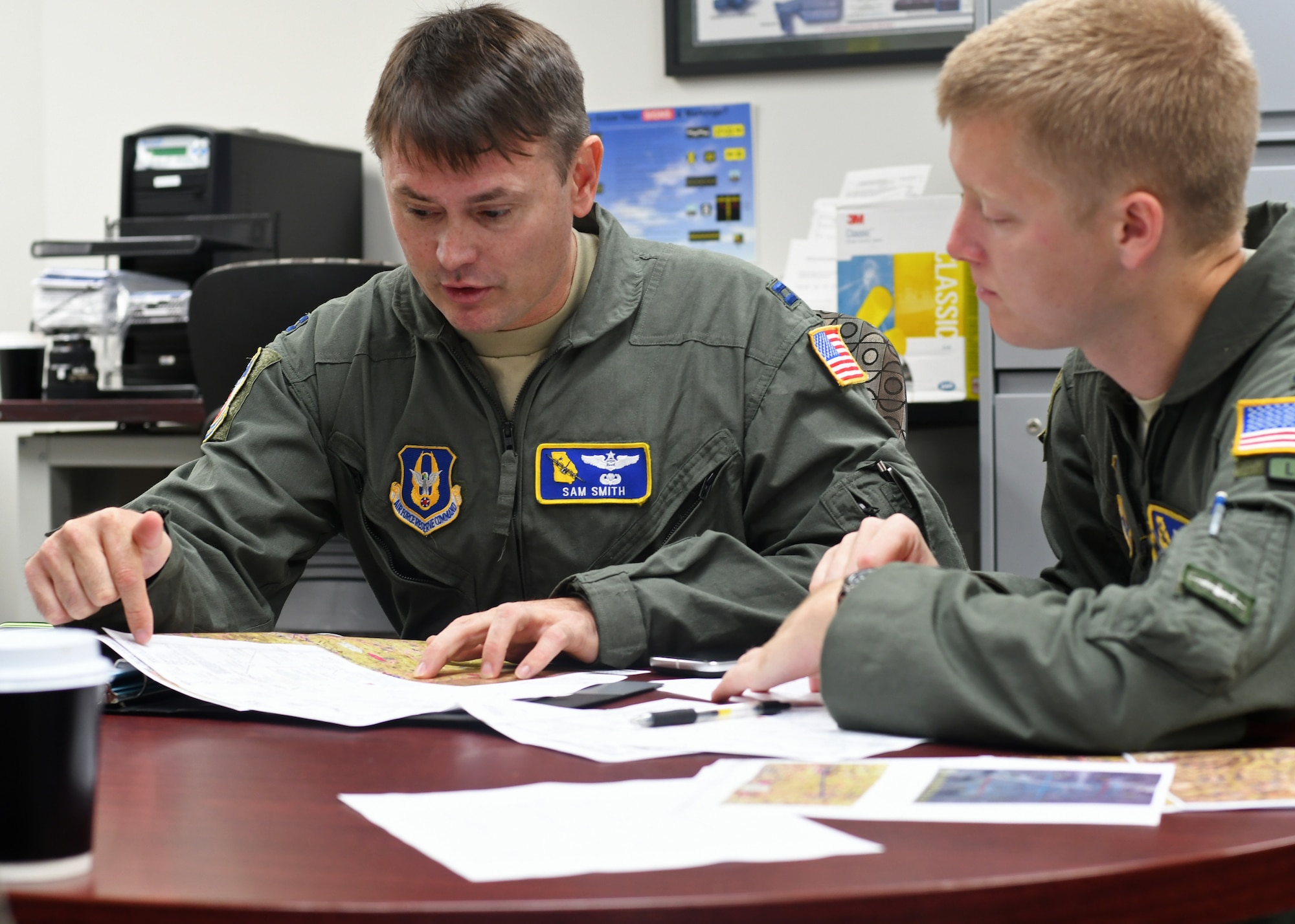 Capt. Sam Smith, 700th Airlift Squadron navigator, and 1st. Lt. Harry Downing, 700th AS pilot, conduct planning prior to a flight at Youngstown Air Reserve Station, Ohio, Aug. 7, 2018. The two, accompanied by the rest of the aircrew, were about to fly in a small formation with C-130 Hercules aircraft from both the 908th AS and the 757th AS. (U.S. Air Force photo by Staff Sgt. Miles Wilson)