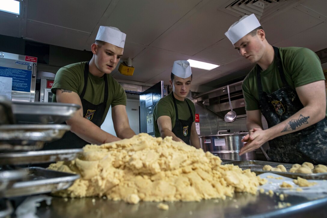 Marines make cookies in the bake shop of the USS Essex.