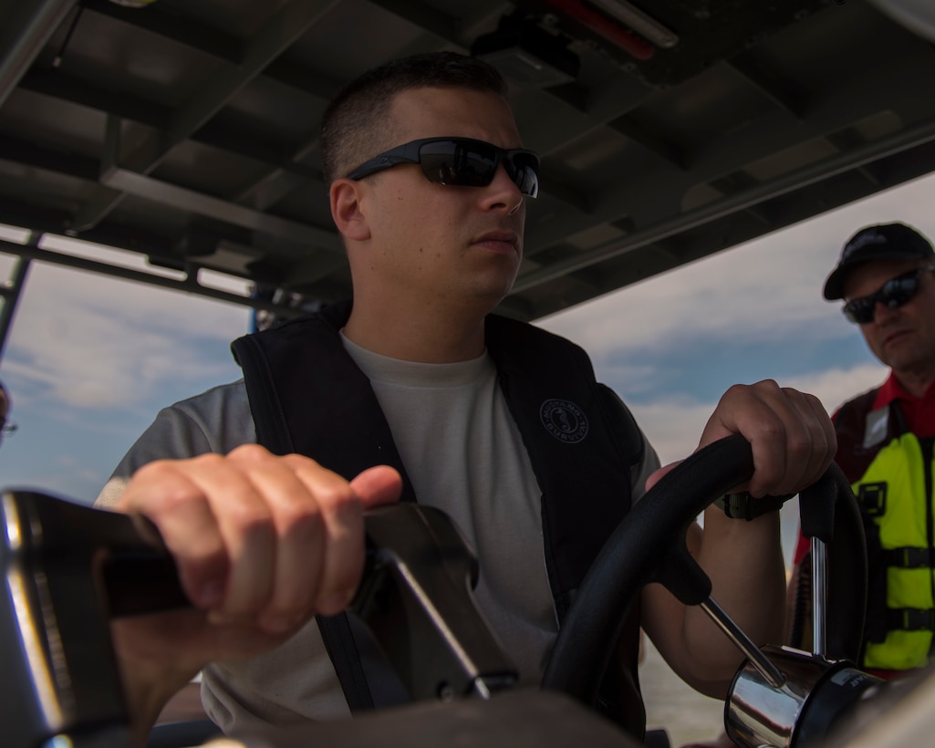 U.S. Air Force Tech. Sgt. Jason Perri, 633rd Security Forces Squadron flight operations flight chief, practices boat maneuvers at Joint Base Langley-Eustis, Virginia, Aug. 14, 2018.