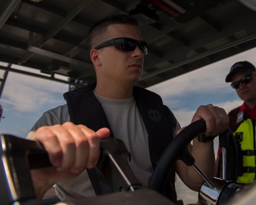 U.S. Air Force Tech. Sgt. Jason Perri, 633rd Security Forces Squadron flight operations flight chief, practices boat maneuvers at Joint Base Langley-Eustis, Virginia, Aug. 14, 2018.