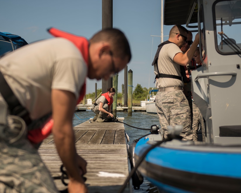 U.S. Air Force Airmen assigned to the 633rd Security Forces Squadron perform boat-docking procedures at Joint Base Langley-Eustis, Virginia, Aug. 14, 2018.