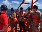 Personnel on ocean mooring, discussing