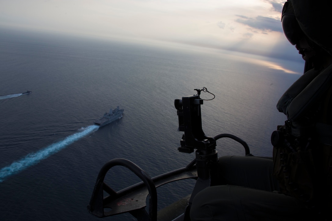 U.S. Marine Corps Sgt. Michael Lewis, an aerial observer with Marine Medium Tiltrotor Squadron 166 Reinforced, 13th Marine Expeditionary Unit, observes Passing Exercise between San Antonio-class amphibious transport dock USS Anchorage and the Sri Lanka Navy while on a regularly scheduled deployment of the Essex Amphibious Ready Group and 13th MEU, August 28, 2018. USS Anchorage and the embarked Marines of the 13th MEU are conducting a theater security cooperation exercise with the Sri Lankan Navy and Navy Marines. Part of a growing U.S.-Sri Lanka naval partnership, the exercise is also an opportunity for U.S. Seventh Fleet to explore local logistics support services for visiting naval forces operating throughout the Indo-Pacific region.
