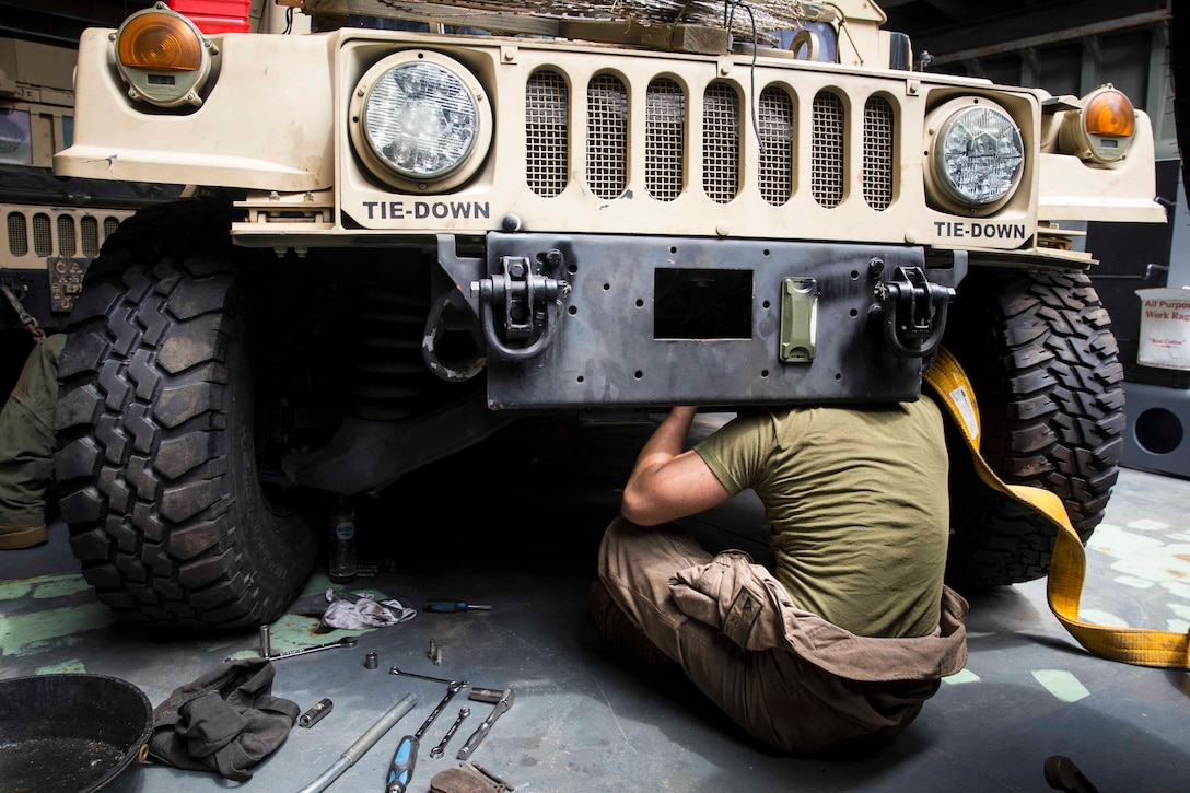 U.S. Marine Cpl. Christopher Vasquez, a motor transport mechanic with Weapons Company, Battalion Landing Team 3/1, 13th Marine Expeditionary Unit, looks under the bumper of a Humvee while aboard the Whidbey Island-class dock landing ship USS Rushmore during a regularly scheduled deployment of Essex Amphibious Ready Group and 13th MEU. The Essex ARG/MEU team is a strong, flexible, responsive, and consistent force capable of maneuver warfare across all domains; it is equipped and scalable to respond to any crisis from humanitarian assistance and disaster relief to contingency operations.