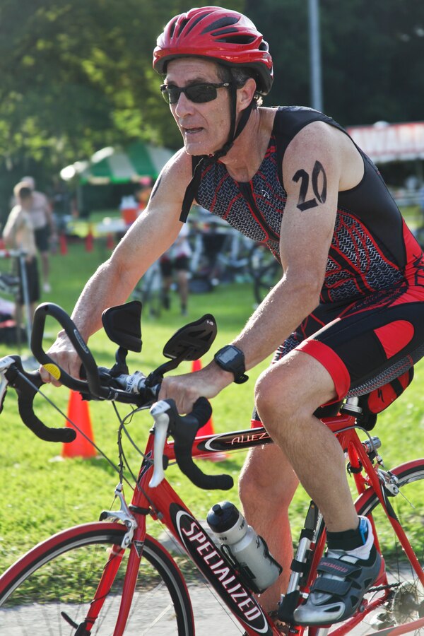 Ricky Davis starts the biking portion of the Marine Corps Community Services’ 19th annual Sprint Triathlon Relay at Marine Corps Air Station Cherry Point, N.C., Aug. 18, 2018. Around 80 participants, including services members and their families from the local community and surrounding area, took part in a 400-meter swim, 10-mile bike ride and a 3-mile run. Athletes braved soaring temperatures and stiff competition in the grueling, but popular event. (U.S. Marine Corps photo by Lance Cpl. Alexandra Santos Arambulo)