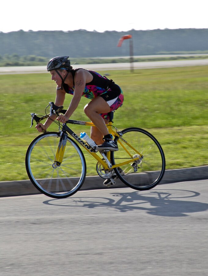 Patricia Rodriguez pedals through the bike ride portion of the Marine Corps Community Services’ 19th annual Sprint Triathlon Relay at Marine Corps Air Station Cherry Point, N.C., Aug. 18, 2018. Around 80 participants, including services members and their families from the local community and surrounding area, took part in a 400-meter swim, 10-mile bike ride and a 3-mile run. Athletes braved soaring temperatures and stiff competition in the grueling, but popular event. (U.S. Marine Corps photo by Lance Cpl. Alexandra Santos Arambulo)
