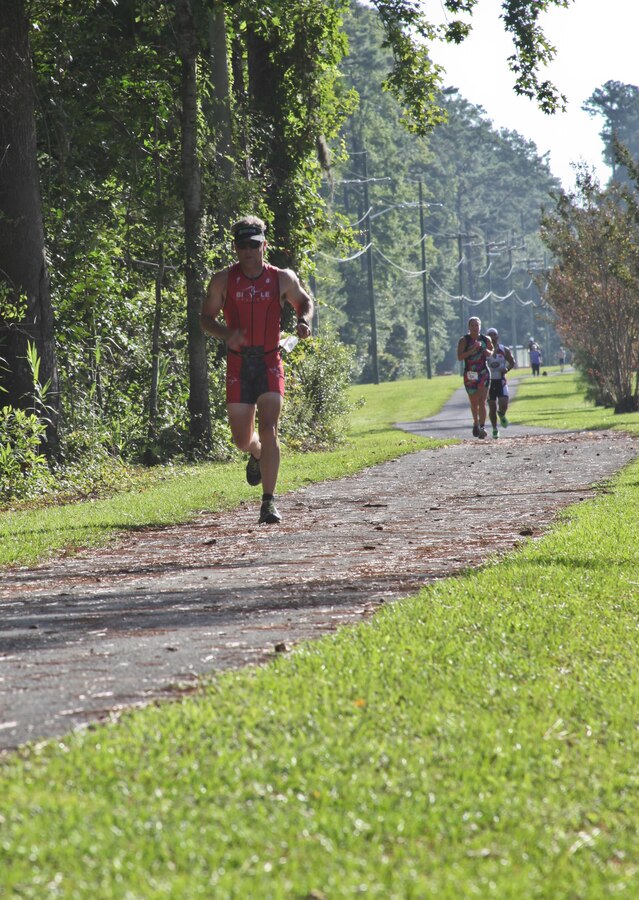 Participants run during the Marine Corps Community Services’ 19th annual Sprint Triathlon Relay at Marine Corps Air Station Cherry Point, N.C., Aug. 18, 2018. Around 80 participants, including services members and their families from the local community and surrounding area, took part in a 400-meter swim, 10-mile bike ride and a 3-mile run. Athletes braved soaring temperatures and stiff competition in the grueling, but popular event. (U.S. Marine Corps photo by Lance Cpl. Alexandra Santos Arambulo)