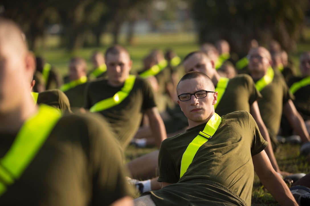 Rct. Ethan Gemzik, a native of Perkasie, Pa., performs a hip stretch after running for physical training Aug. 15, 2018, on Parris Island, S.C. Recruits must stretch after physical training in order to avoid any injuries.