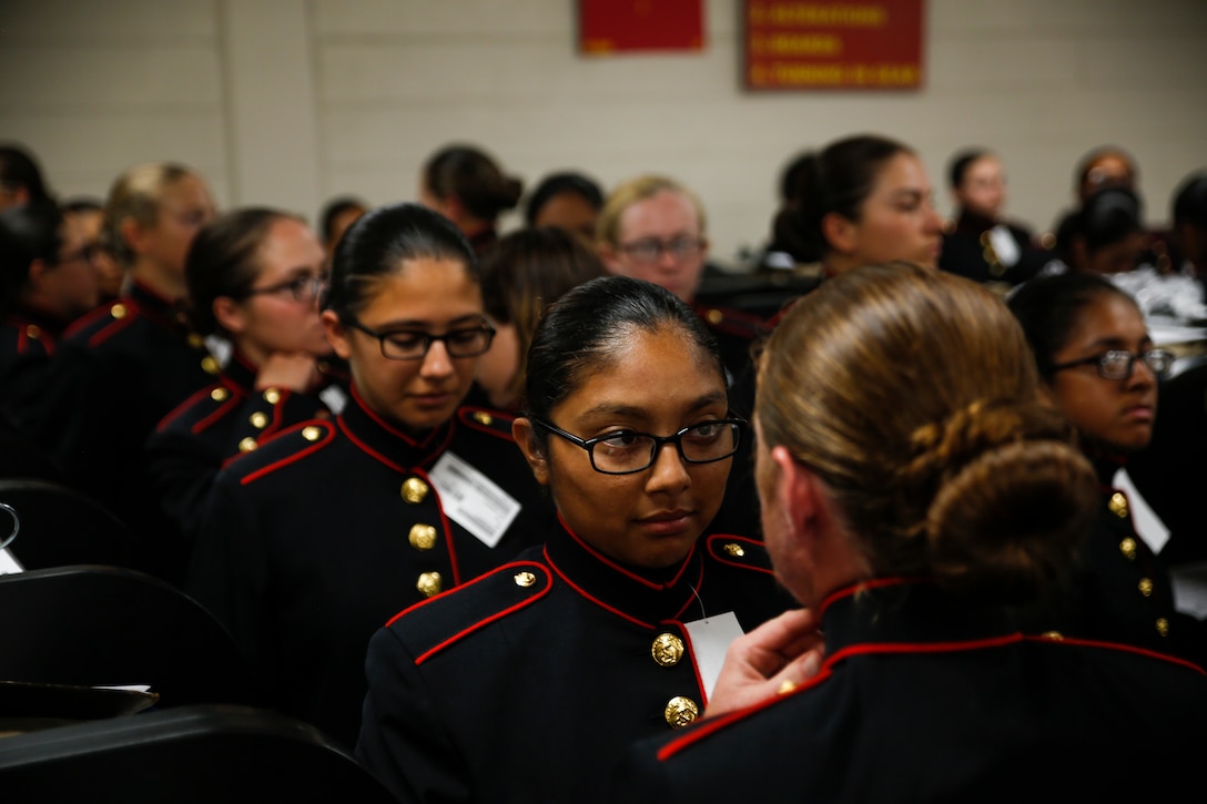 Recruits with Platoon 4040, Papa Company, 4th Recruit Training Battalion, try on their blue dress coats for the first time Aug. 21, 2018, on Parris Island S.C. The recruits are part of the first female company to be issued the new female blue dress coat, which features a mandarin collar.