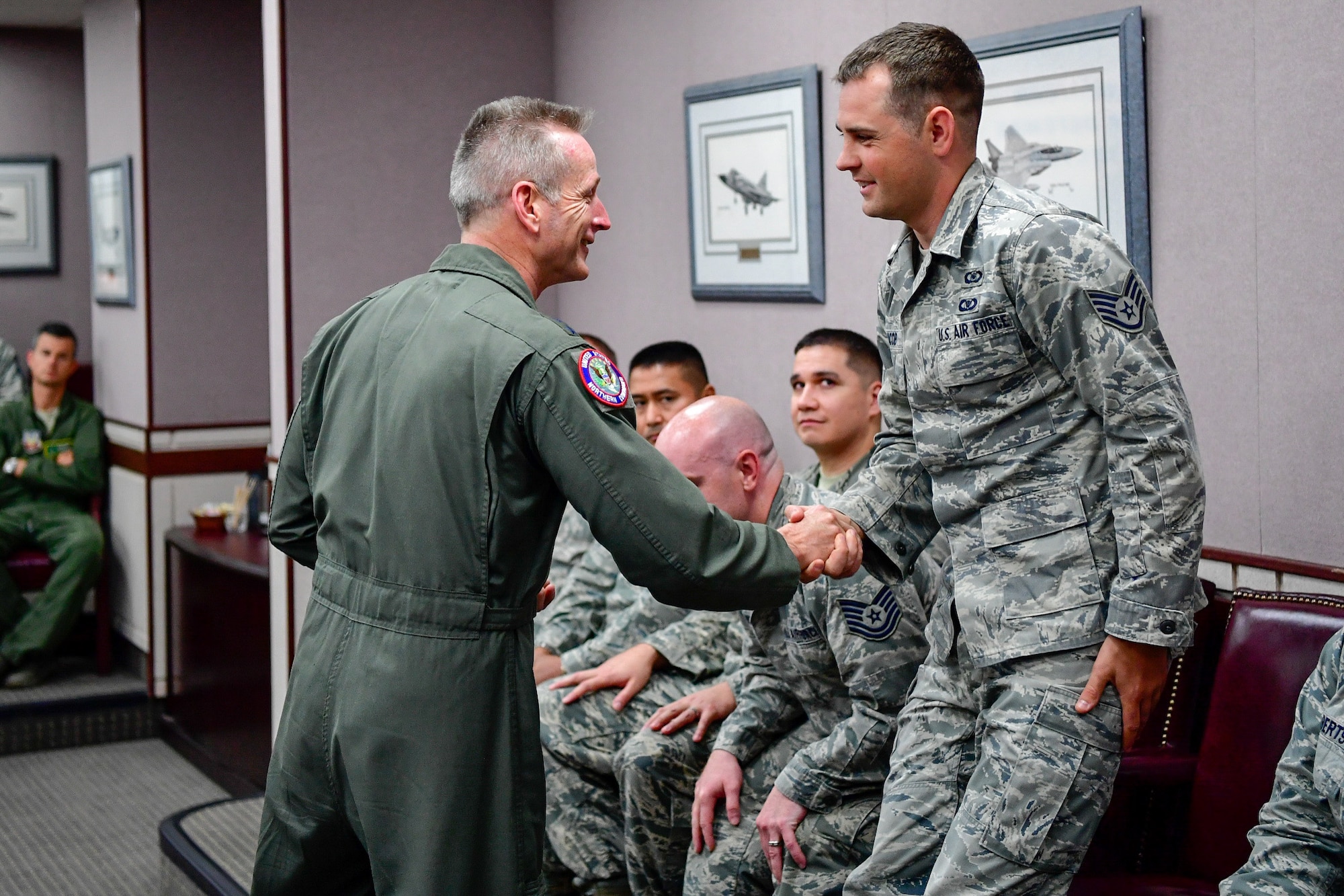 Gen. Terrence O'Shaughnessy, NORAD and USNORTHCOM commander, recognizes Staff Sgt. David Jacob, 225th Air Defense Squadron weapons director, with a commander’s coin for the critical role he played during the Aug. 10, 2018 F-15 fighter intercept of the stolen Horizon Bombardier Q400 aircraft out of SeaTac International Airport.  O'Shaughnessy visited the WADS Aug. 23 in order to commend the WADS operations crew for their expert command and control of the 142nd Fighter Wing's F-15 intercept of the stolen aircraft. (U.S. Air National Guard photo by Maj. Kimberly D. Burke)