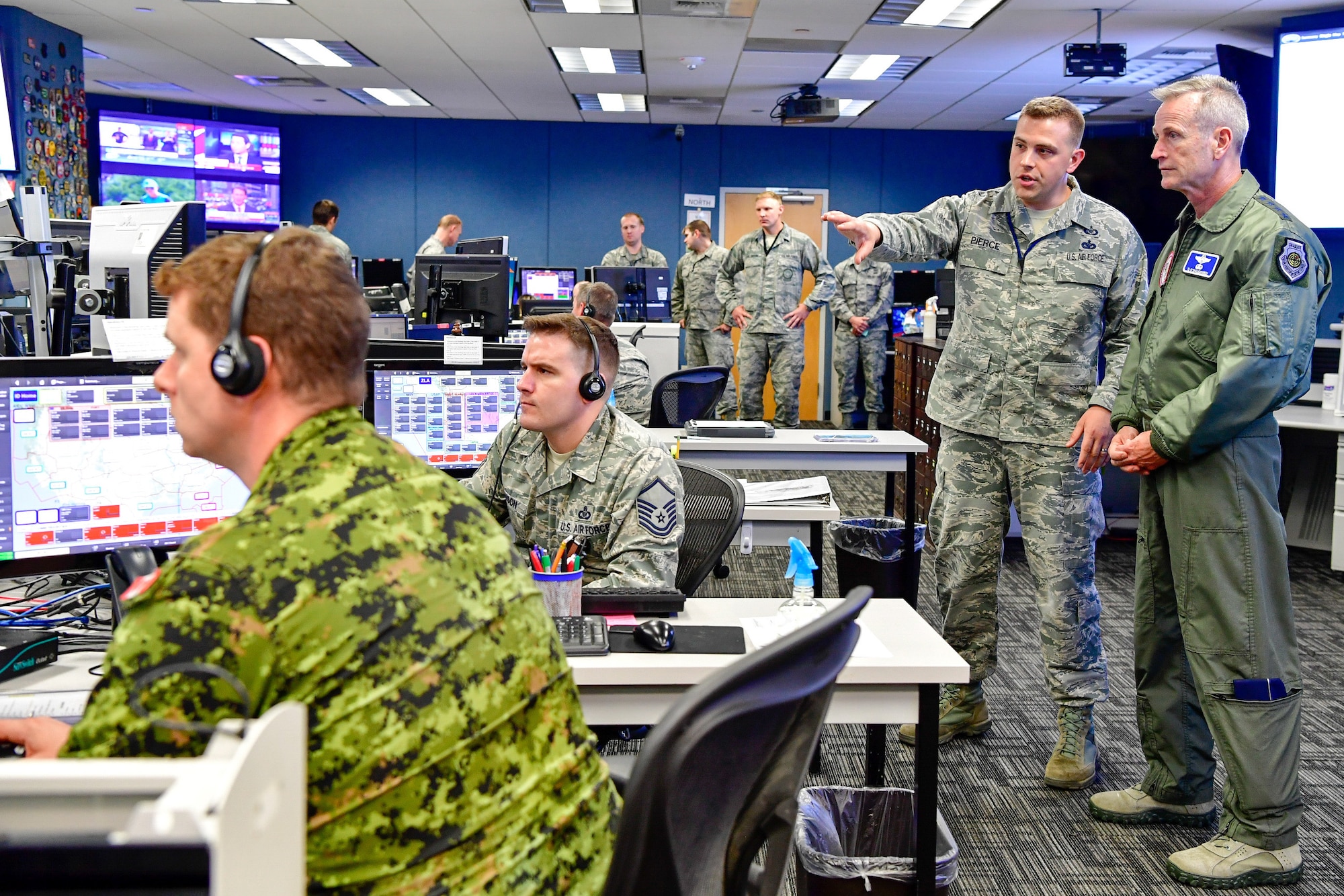 Master Sgt. Donald Pierce, 225th Air Defense Squadron air surveillance technician, answers Gen. Terrence O'Shaughnessy, NORAD and USNORTHCOM commander, questions during his visit to the Western Air Defense Sector, Joint Base Lewis-McChord, Washington Aug. 23, 2018.  O'Shaughnessy received a tour of the operations floor and met with the WADS crew that provided command and control of the 142nd Fighter Wing's F-15 intercept of the Aug. 10 stolen Horizon Bombardier Q400 aircraft out of SeaTac International Airport. (U.S. Air National Guard photo by Maj. Kimberly D. Burke)