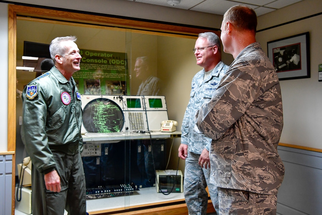 Col. William Krueger (center), 225th Air Defense Group commander, shows Gen. Terrence O'Shaughnessy, NORAD and USNORTHCOM commander, the technology the Western Air Defense Sector was using during the 9/11 attacks.  O'Shaughnessy met with the WADS operations crew that provided command and control of the 142nd Fighter Wing's F-15 intercept of the Aug. 10 stolen Horizon Bombardier Q400 aircraft out of SeaTac International Airport. (U.S. Air National Guard photo by Maj. Kimberly D. Burke)